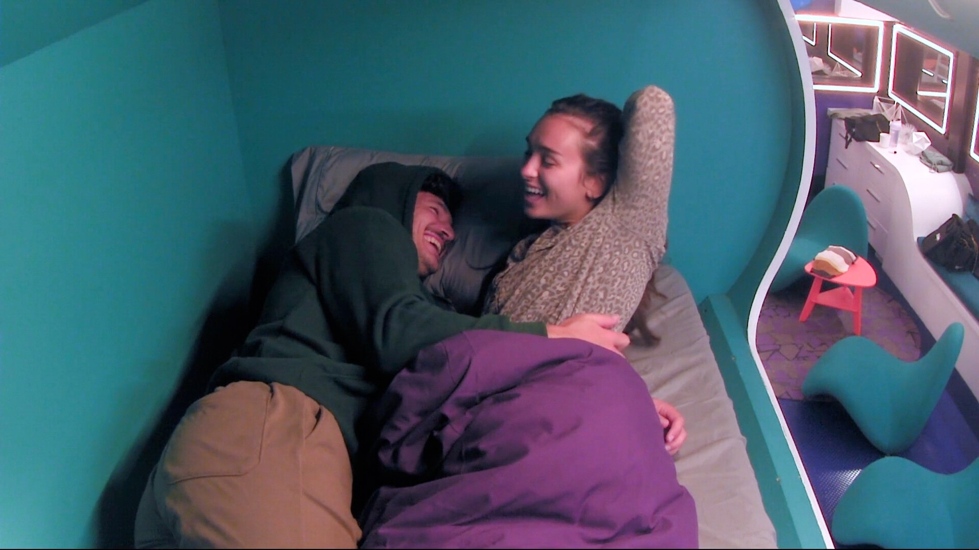 Rome and Lyric cuddle in bed.