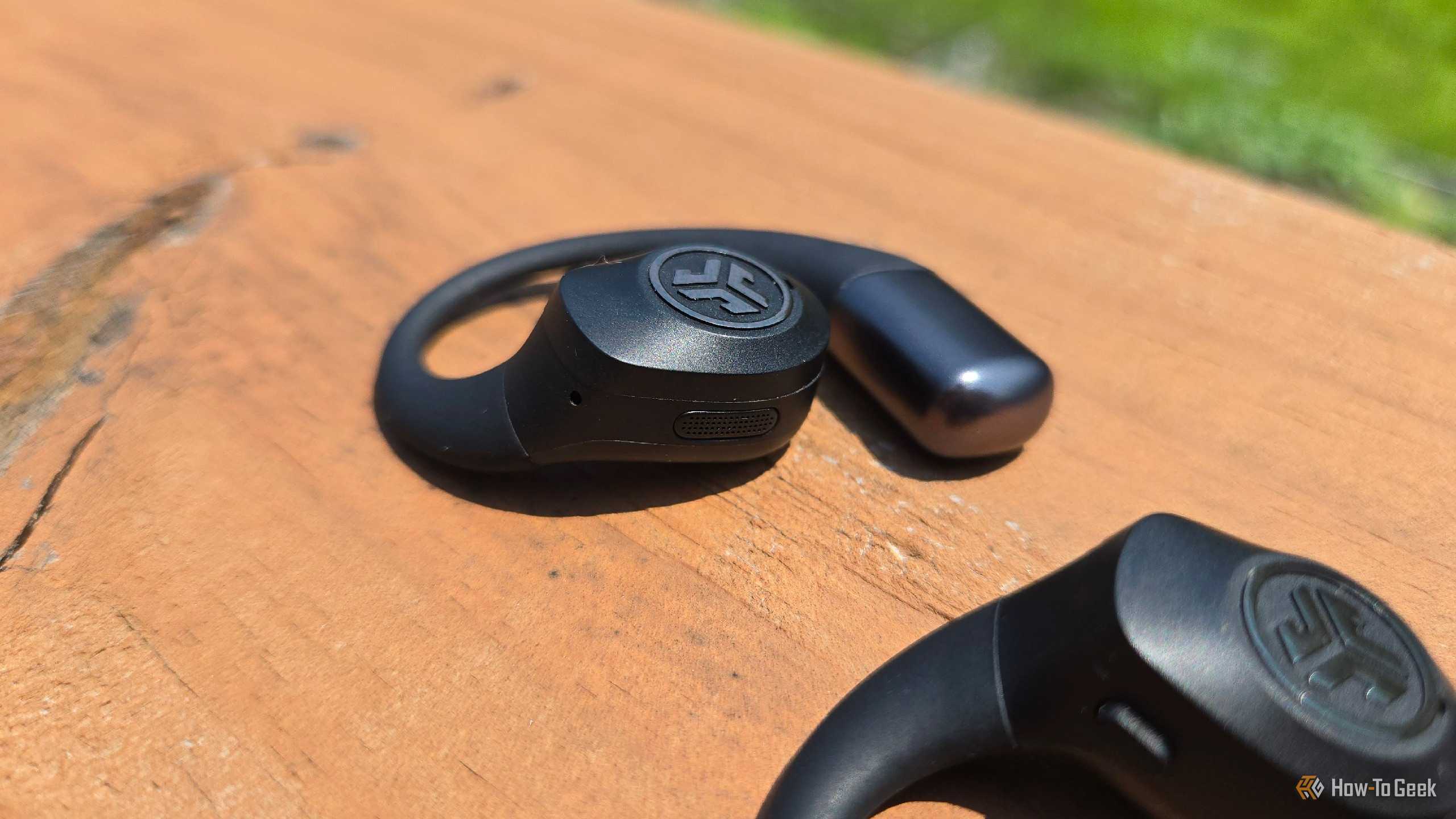 The side of a JLab Epic Open Sport earbud.