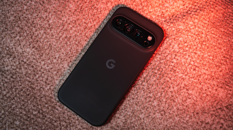 A black Pixel 10 Pro face-down on carpet