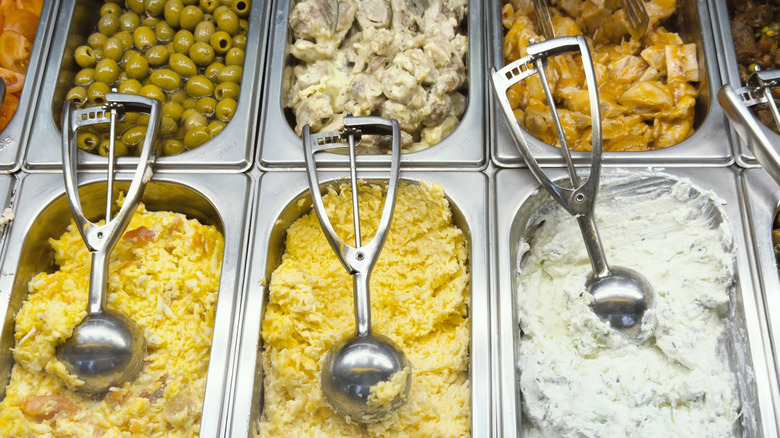 Salads, dips, and olives in deli counter