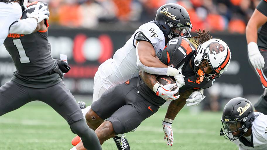 Oregon State Beavers running back Anthony Hankerson (0) is tackled after a run by Wake Forest Demon Deacons linebacker Langst