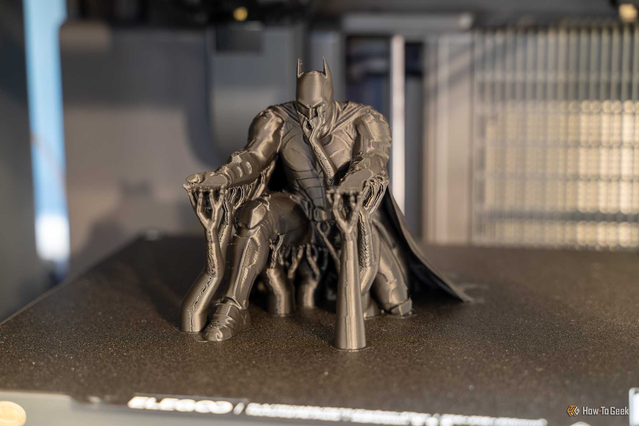 Elegoo Centauri 2 Batman pen holder print on build plate with tree supports.