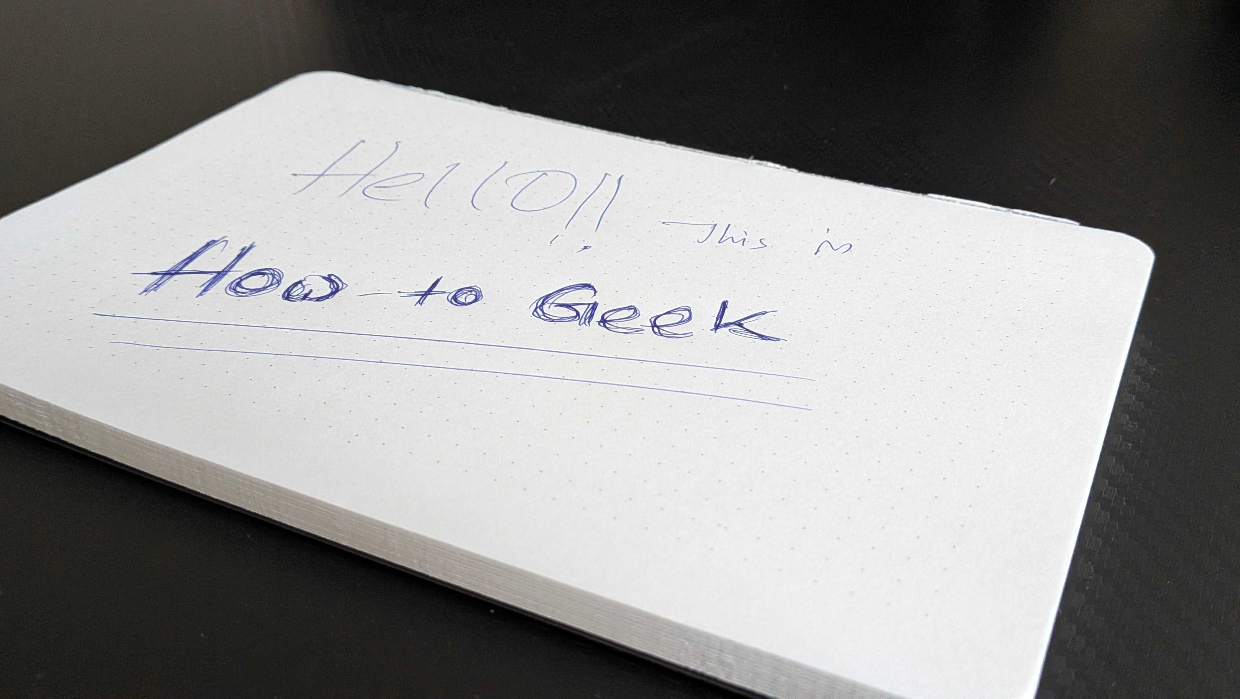 Notepad cover page handwritten Hello this is How to Geek.