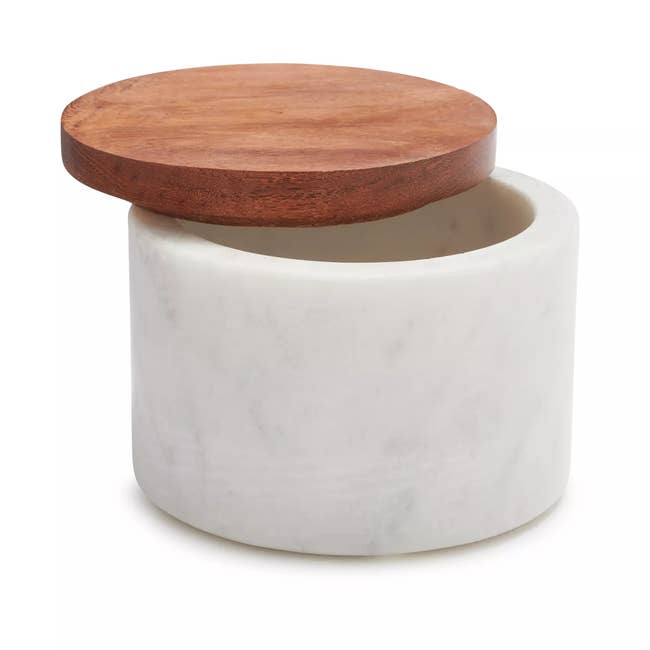 Marble storage container with a round wooden lid, suitable for kitchen or home organization