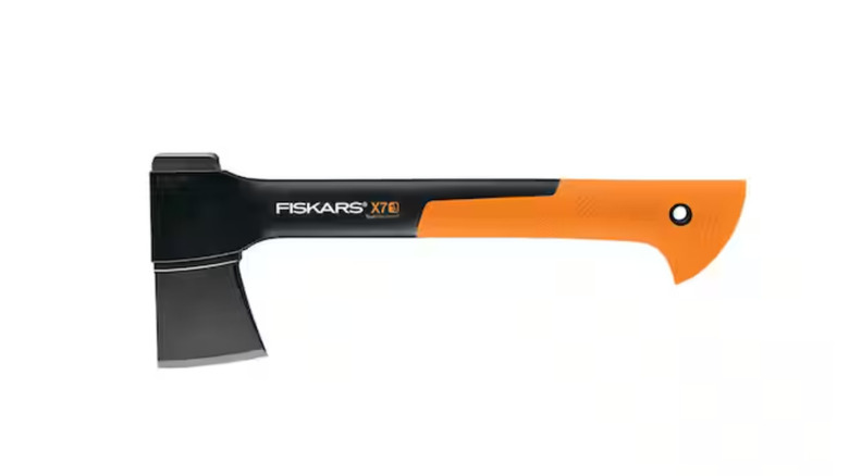 cutting tree branches with Fiskars hatchet