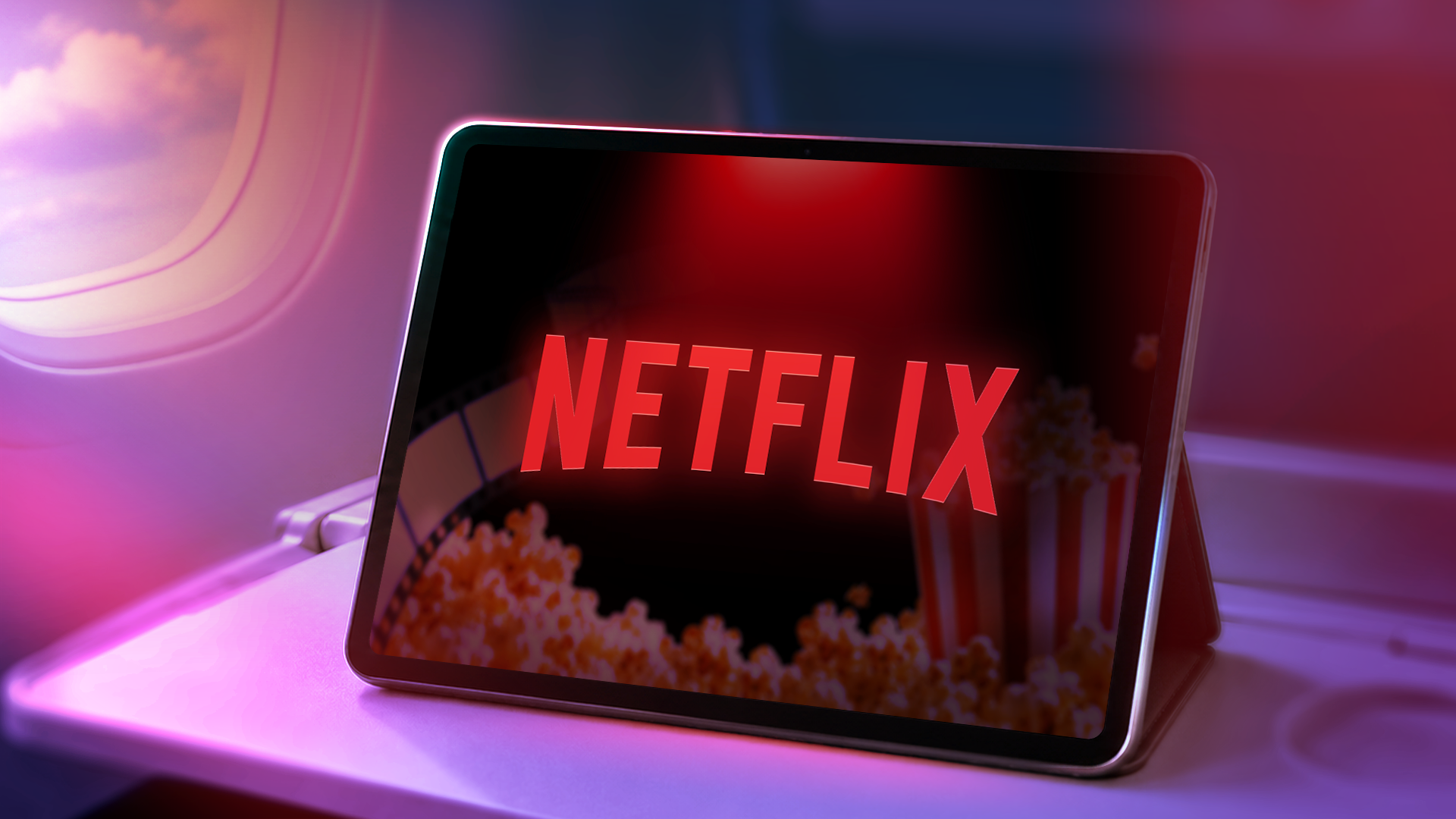 A tablet on an airplane tray table showing the Netflix logo with haze