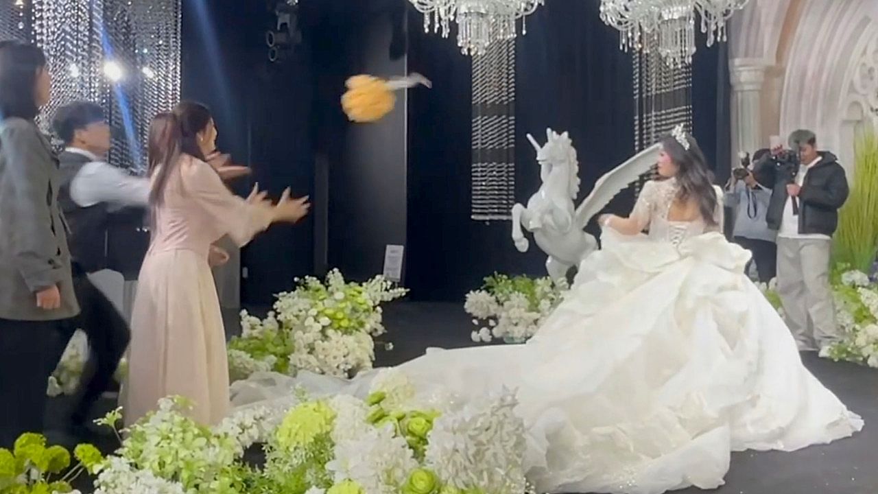 Overeager wedding guest turns the bouquet toss into an embarrassing mishap