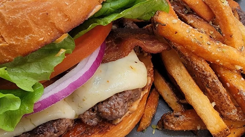 Cheeseburger with peanut butter, onion, lettuce, and tomato with fries