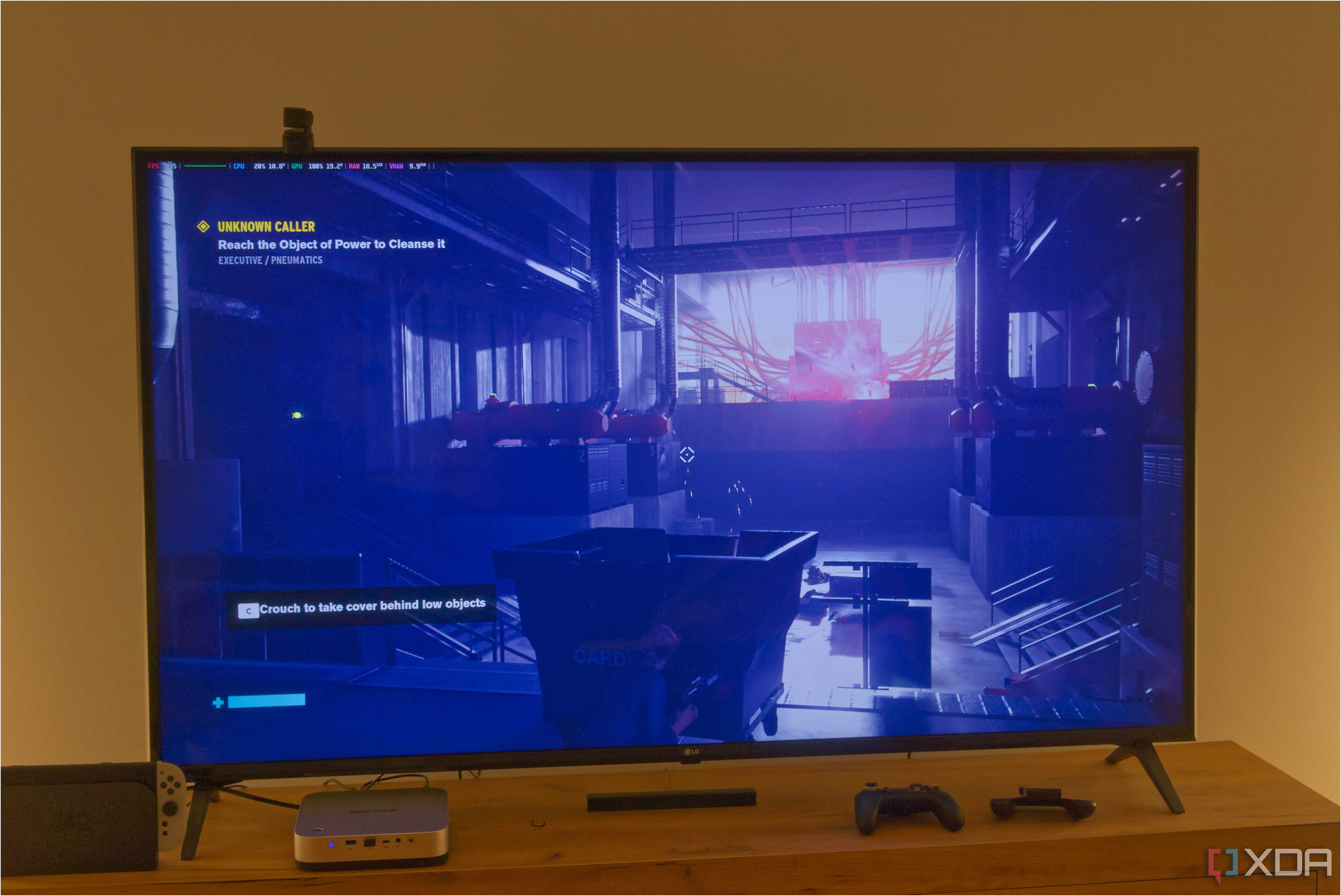 A TV displaying Control running on Bazzite with a performance overlay in the top left corner