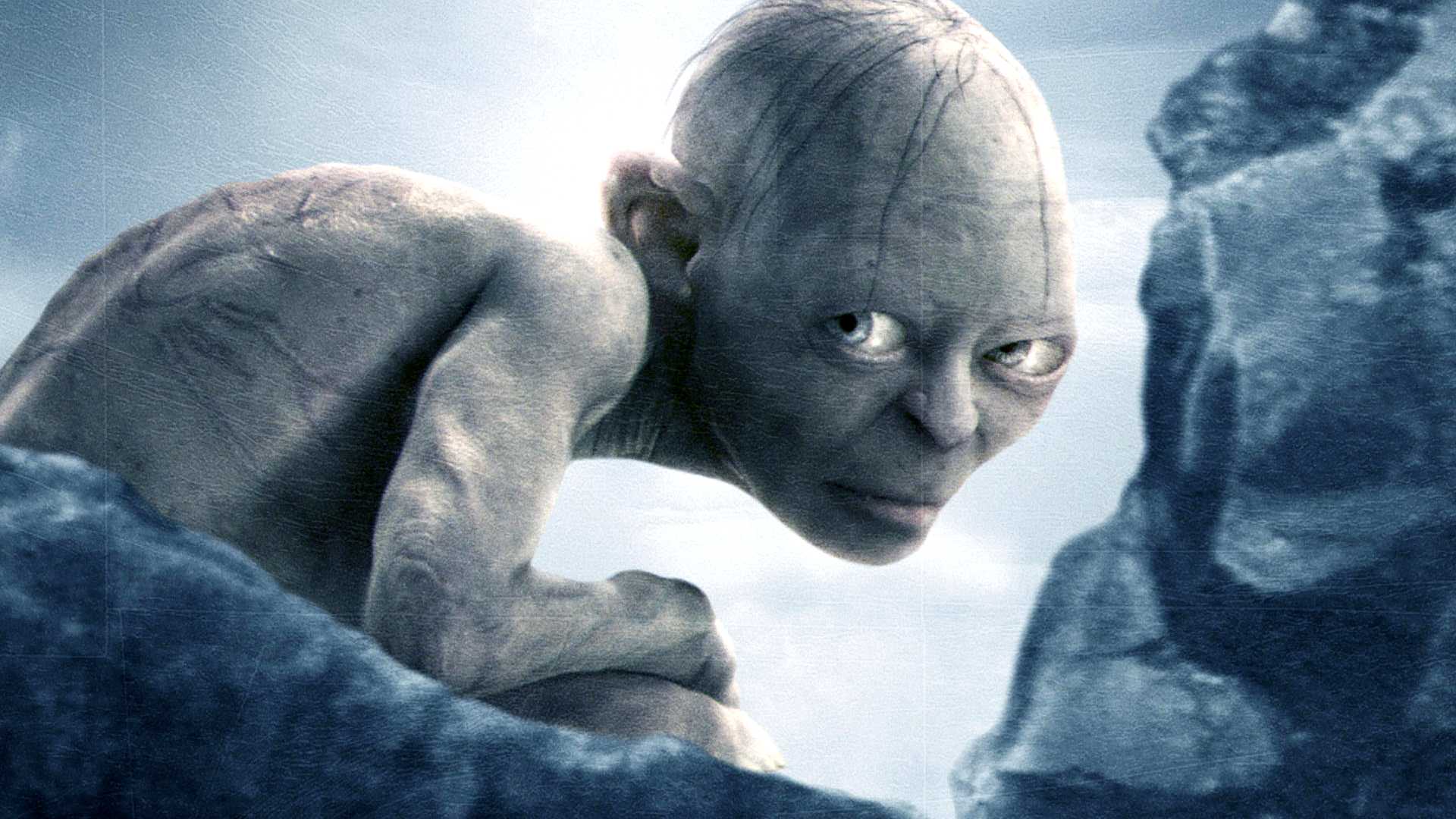 Gollum glaring from behind rocks in a promotional image for The Lord of the Rings The Return of the King
