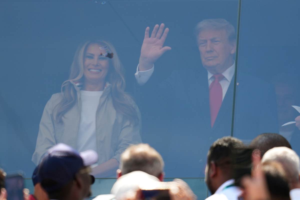 President Donald J. Trump stands with first lady Melania Trump during the World Cup final soccer match between Spain and Argentina in East Rutherford, N.J., near New York, Sunday, July 19, 2026. (AP Photo/Julio Cortez)