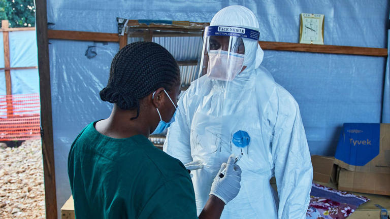 Health workers interact at a medical centre in Bunia. File pic: AP