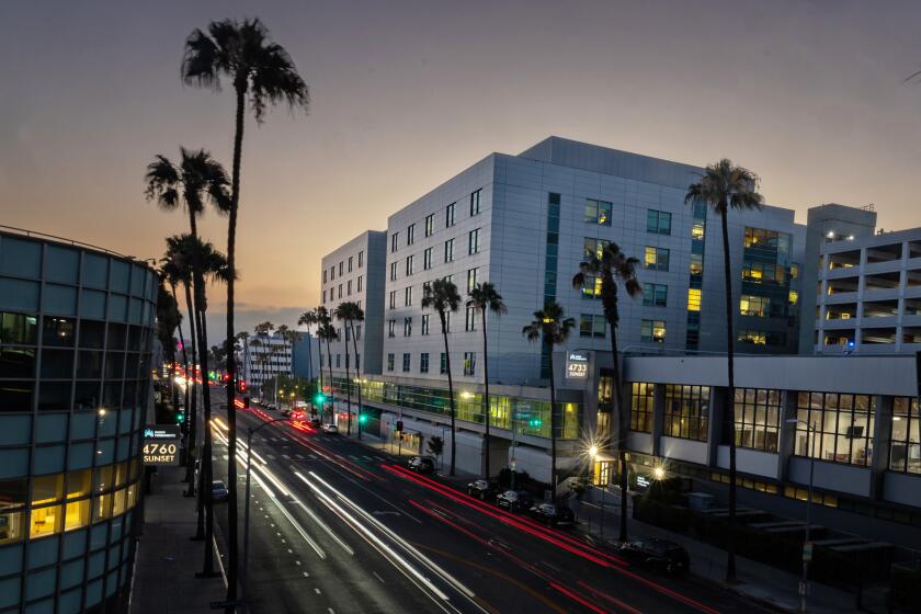 A slow-exposure shot of cars streaking past Kaiser Permanente at 4867 Sunset Blvd.