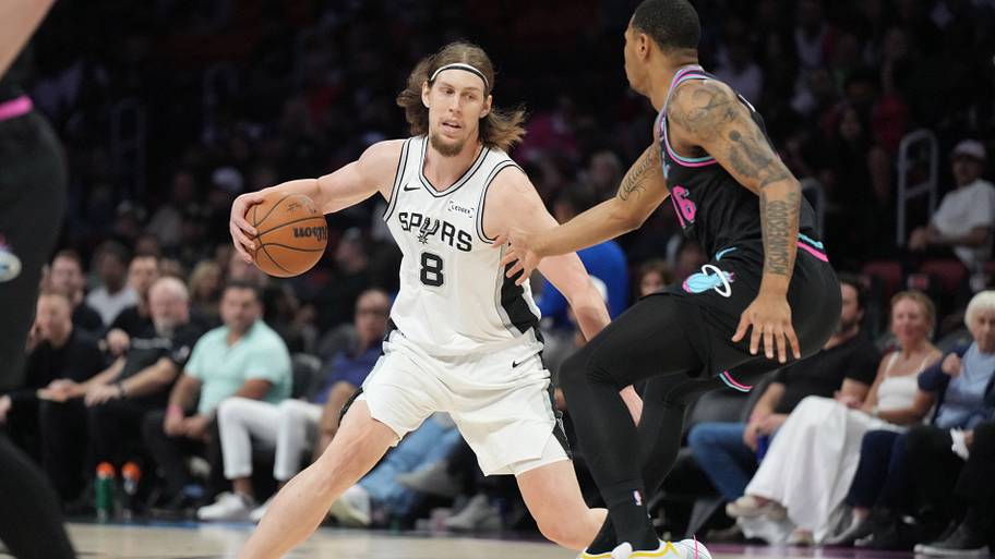 San Antonio Spurs forward Kelly Olynyk (8) brings th ball up the court as Miami Heat forward Keshad Johnson defends
