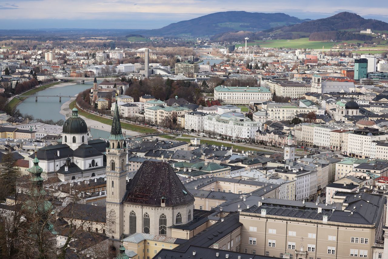 Aerial view of Salzburg Austria featuring the distinctive domes river and surrounding hills