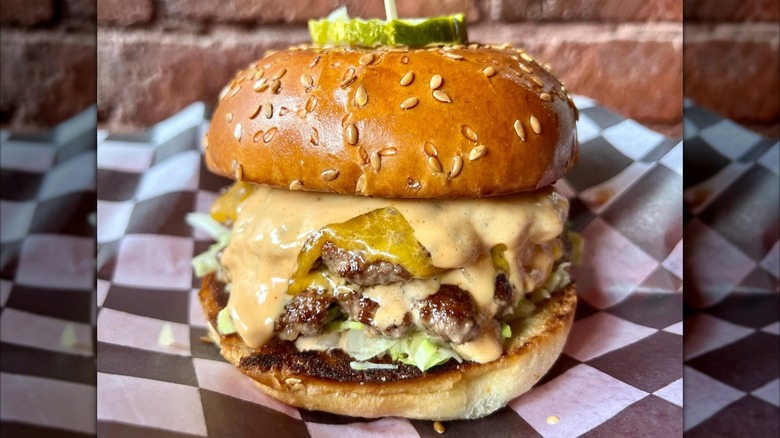 Double cheeseburger with sauce, lettuce, and pickle