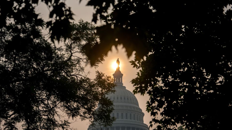 The sun rises above the US Capitol on July 17. - Julia Demaree Nikhinson/AP