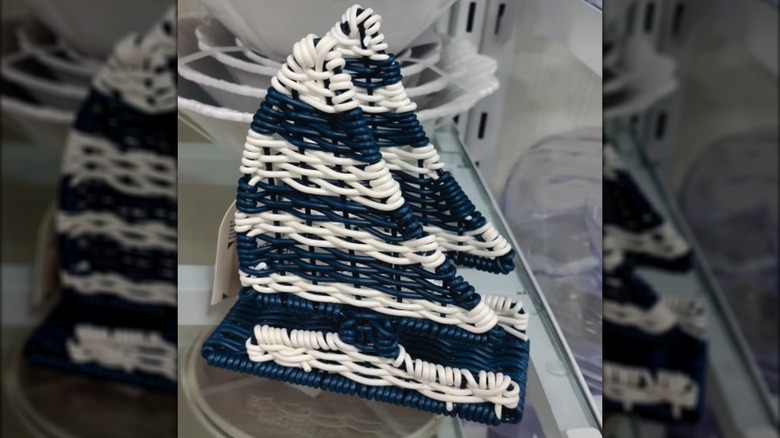 Blue and white sailboat shaped wicker napkin holder at HomeGoods.