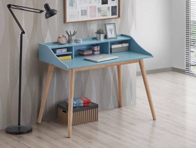 Wooden desk with shelves, books, and decor in a minimalist home office setup
