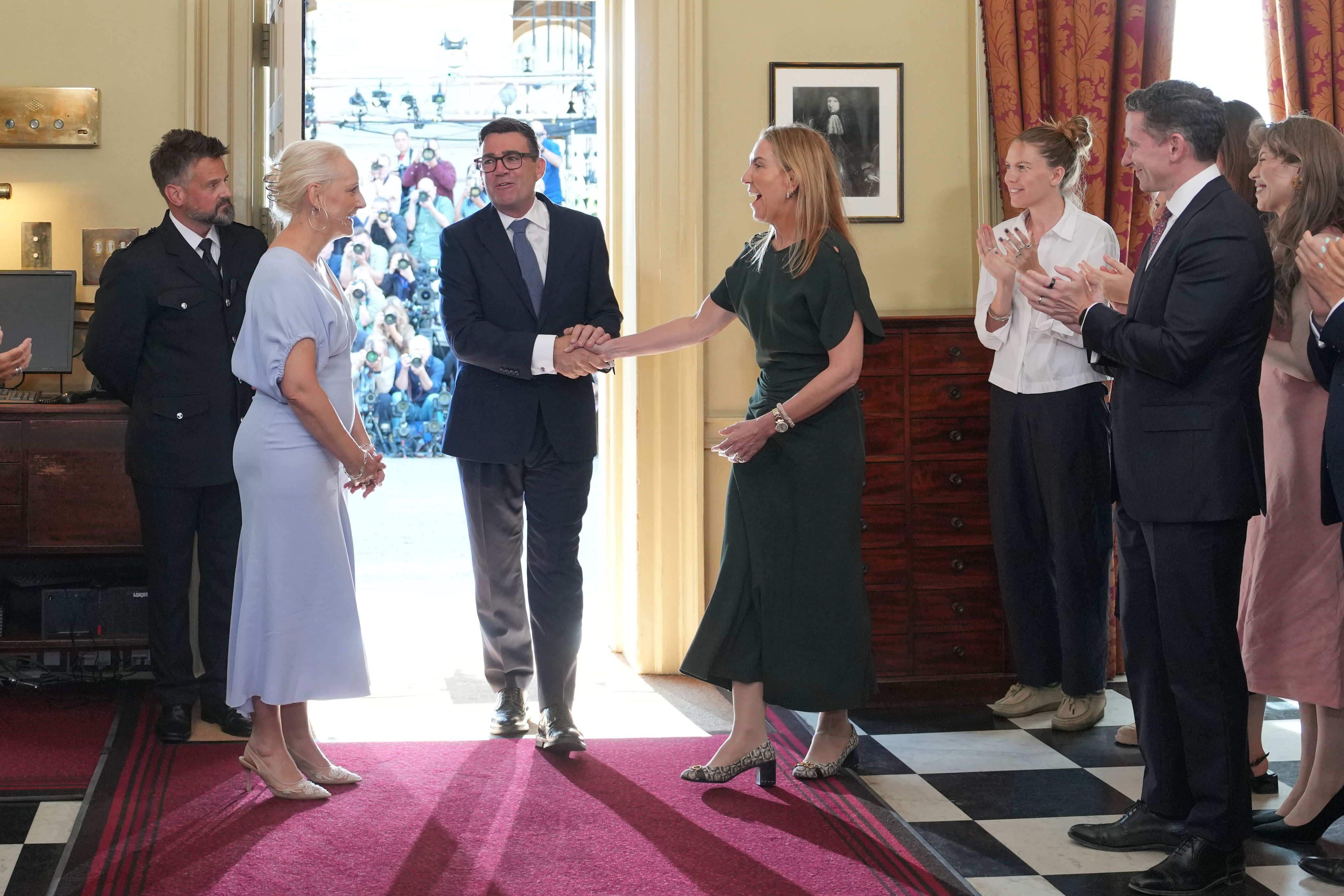 New Prime Minister Andy Burnham shakes hands with Dame Antonia Romeo as he walks into 10 Downing Street (PA)