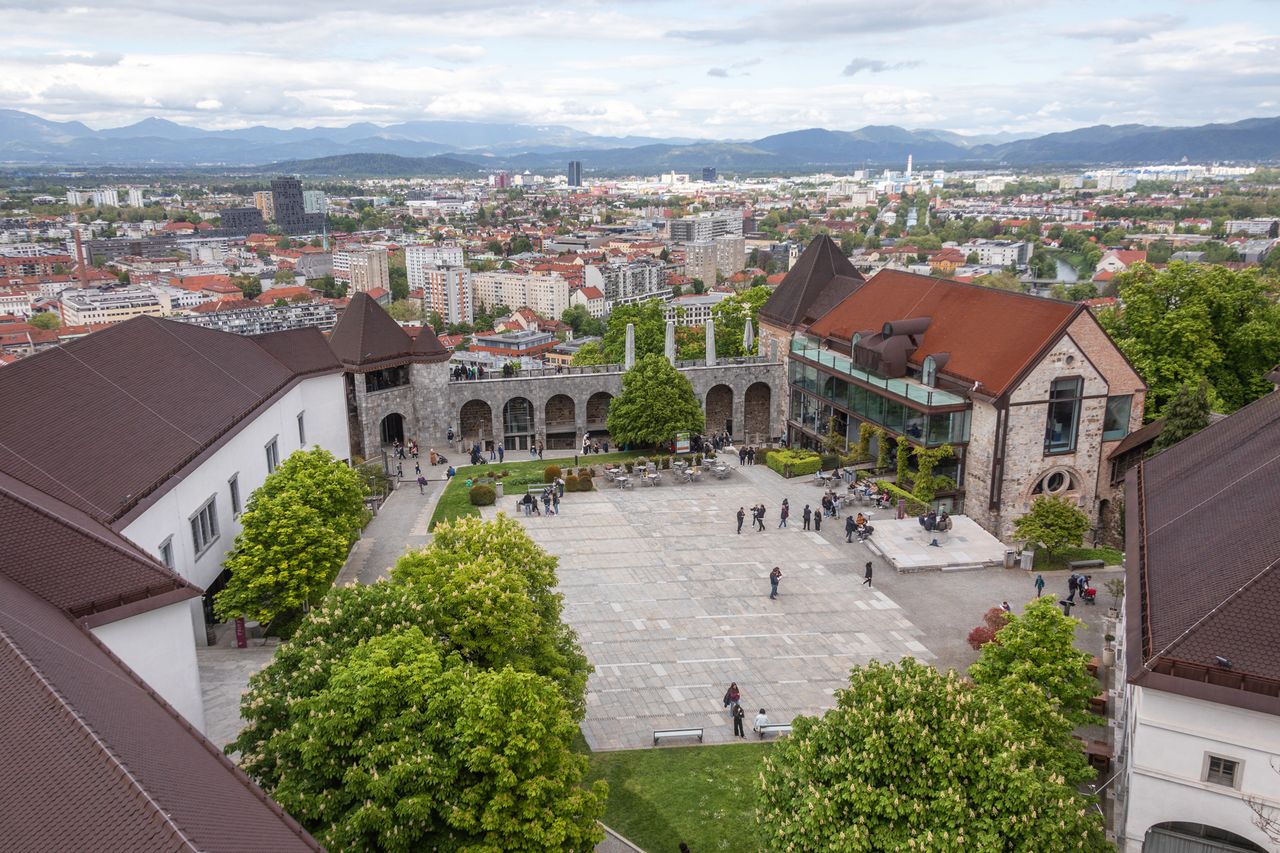 A scenic view of a courtyard with historical buildings in a cityscape Ljubljana Castle in Slovenia
