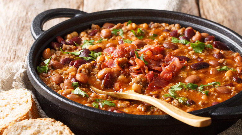 A skillet of chili on a wooden table