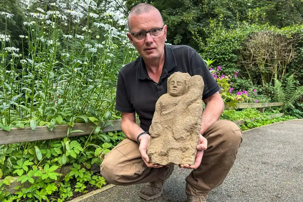 Dr. Andrew Birley with the Genius he discovered. Credit: Vindolanda Charitable Trust