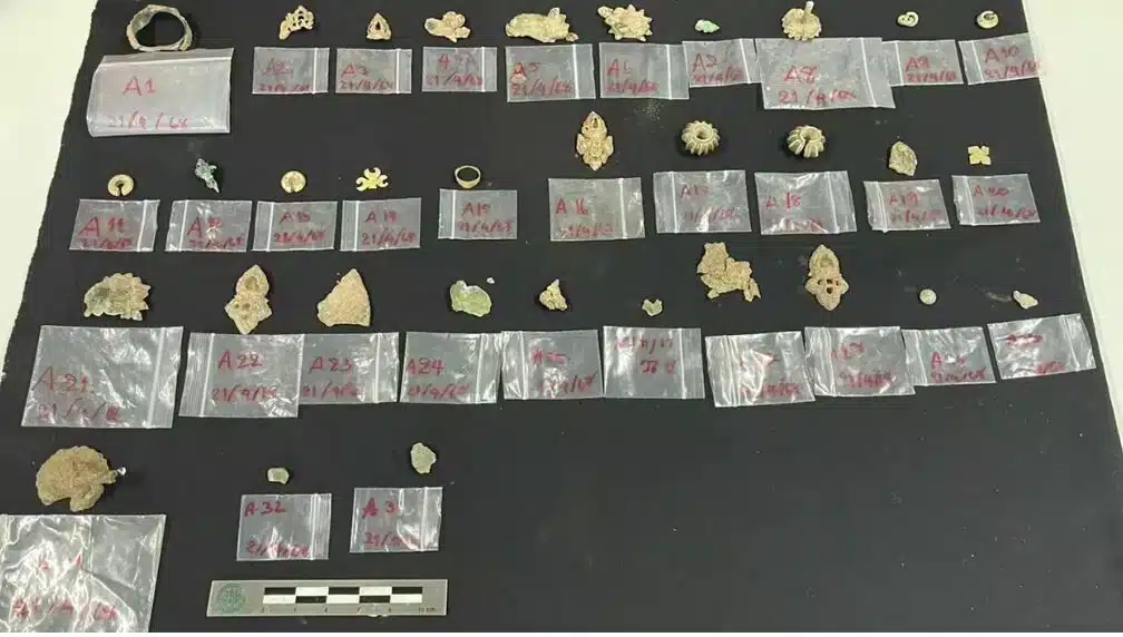 Ancient gold, silver, and bronze ornaments discovered inside a ceramic container beneath the Wat Thammachak Sema Ram temple complex in Thailand. Credit: Thailand’s Fine Arts Department
