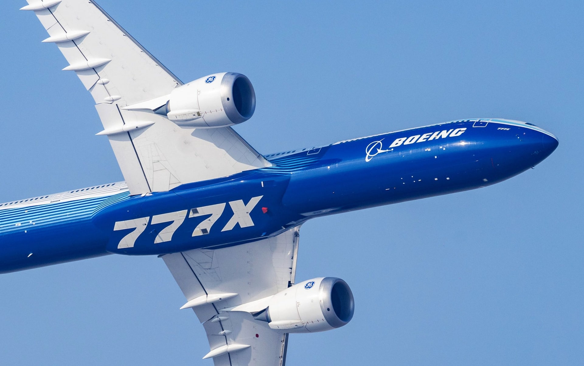 An experimental Boeing 777X aircraft flying in 2025