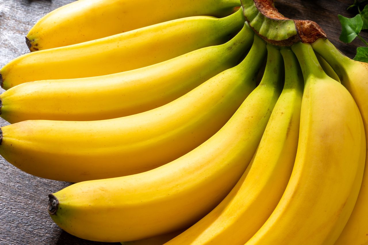 A bunch of bananas on a wooden surface