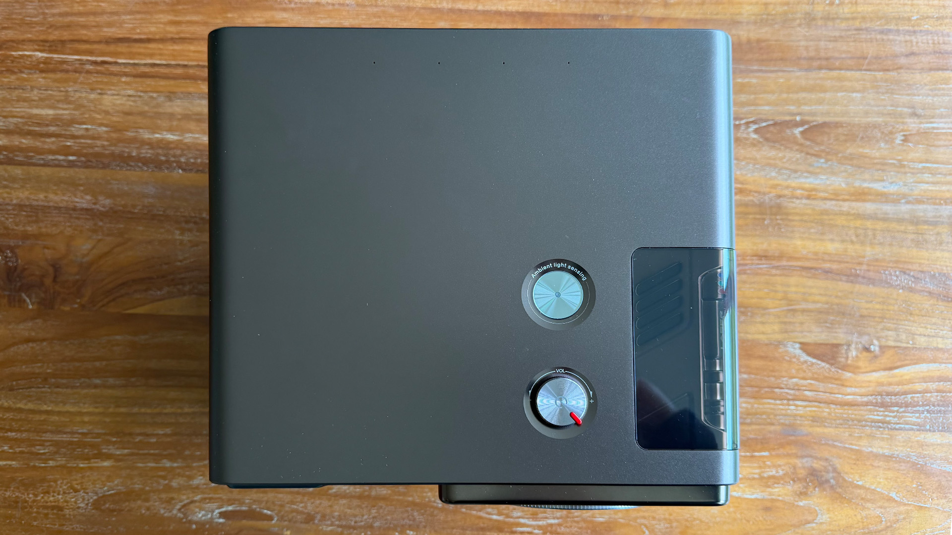 Hisense XR10 home cinema projector on wooden table top down view