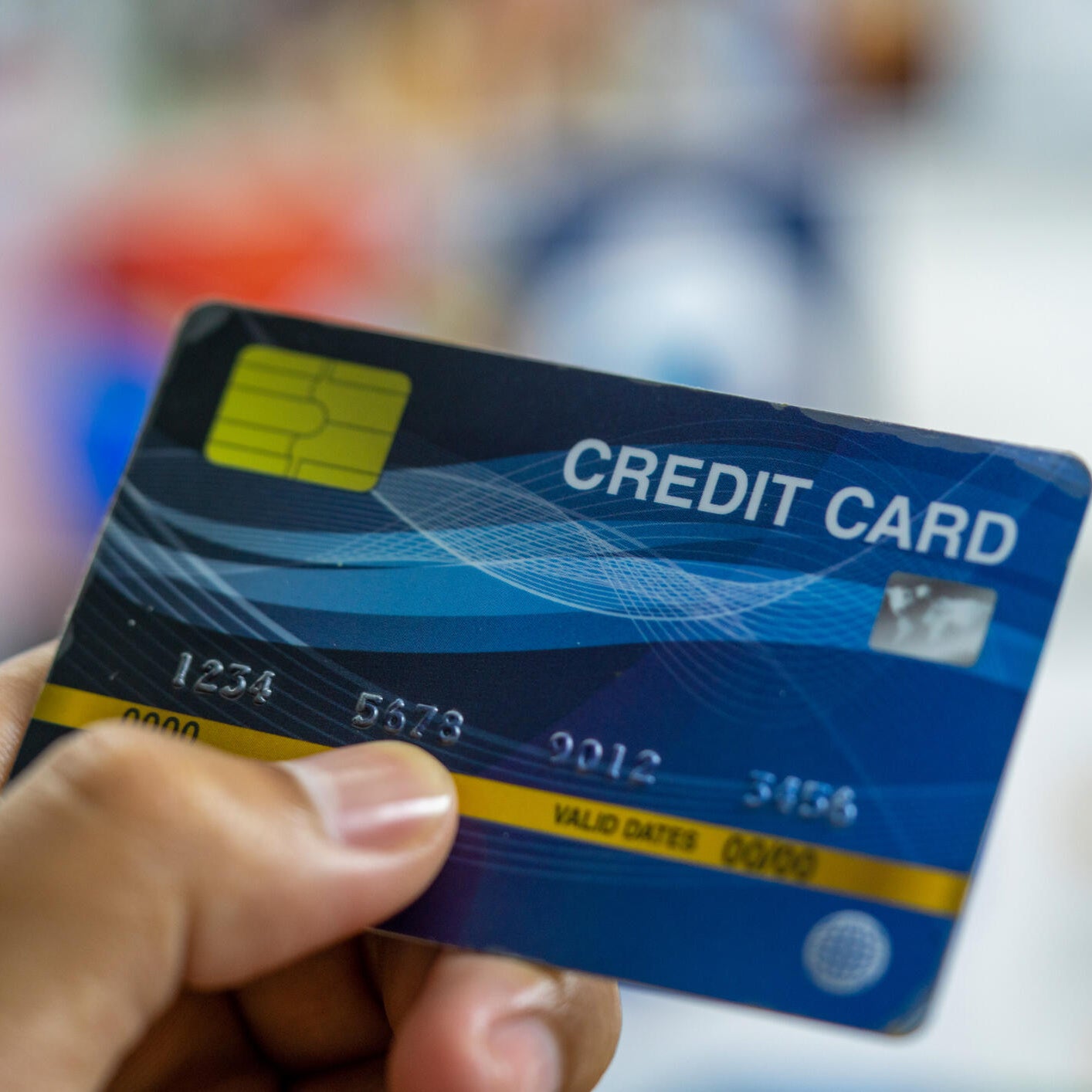 Close up a man hand holding a blue credit card.