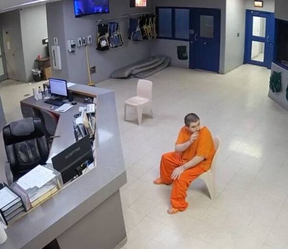 Gary Siders Jr. waves and signals to Elizabeth he loves her as he's booked into Southeastern Ohio Regional Jail.