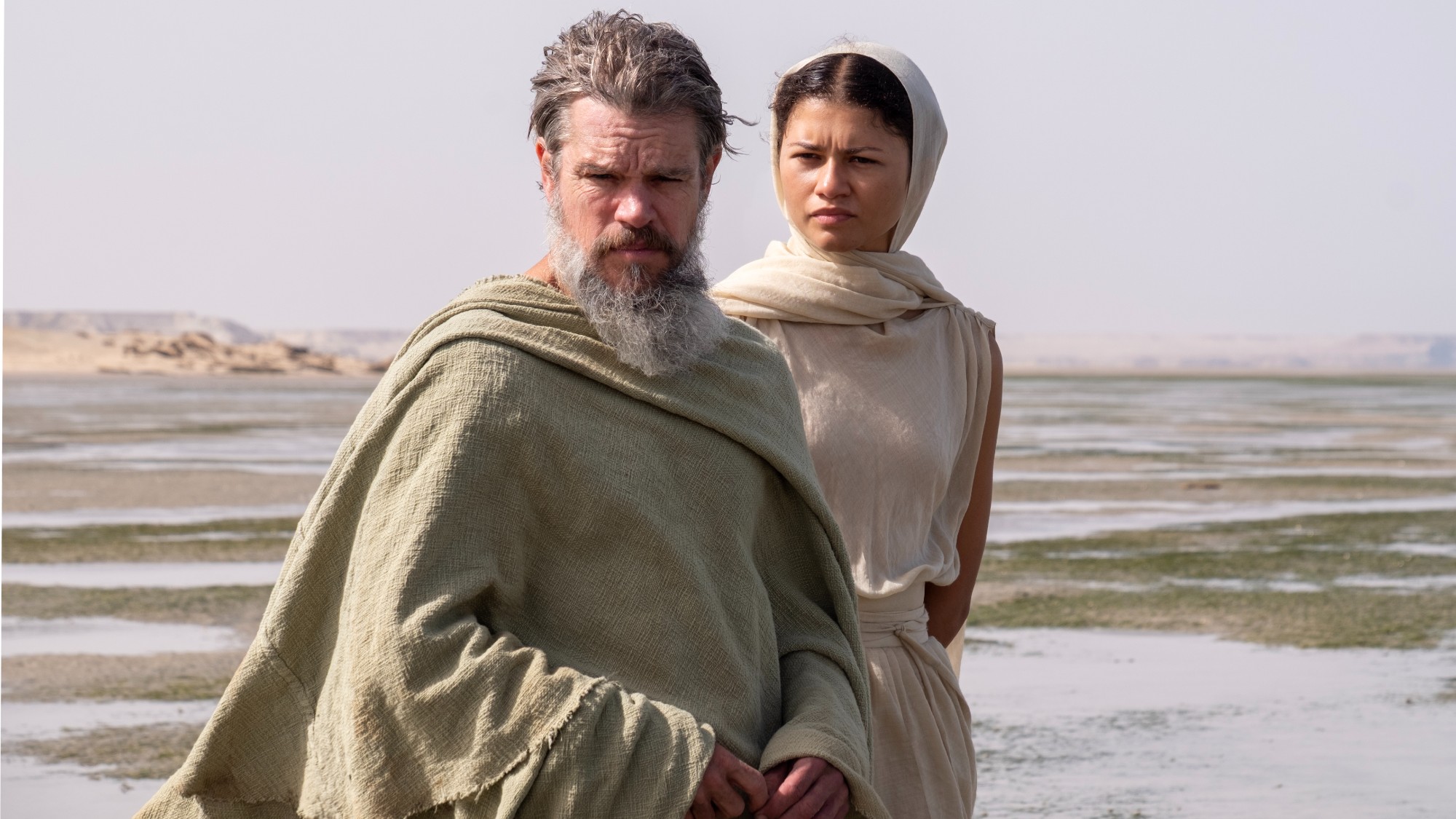 L to R: Matt Damon is Odysseus and Zendaya is Athena in THE ODYSSEY, written, produced, and directed by Christopher Nolan.