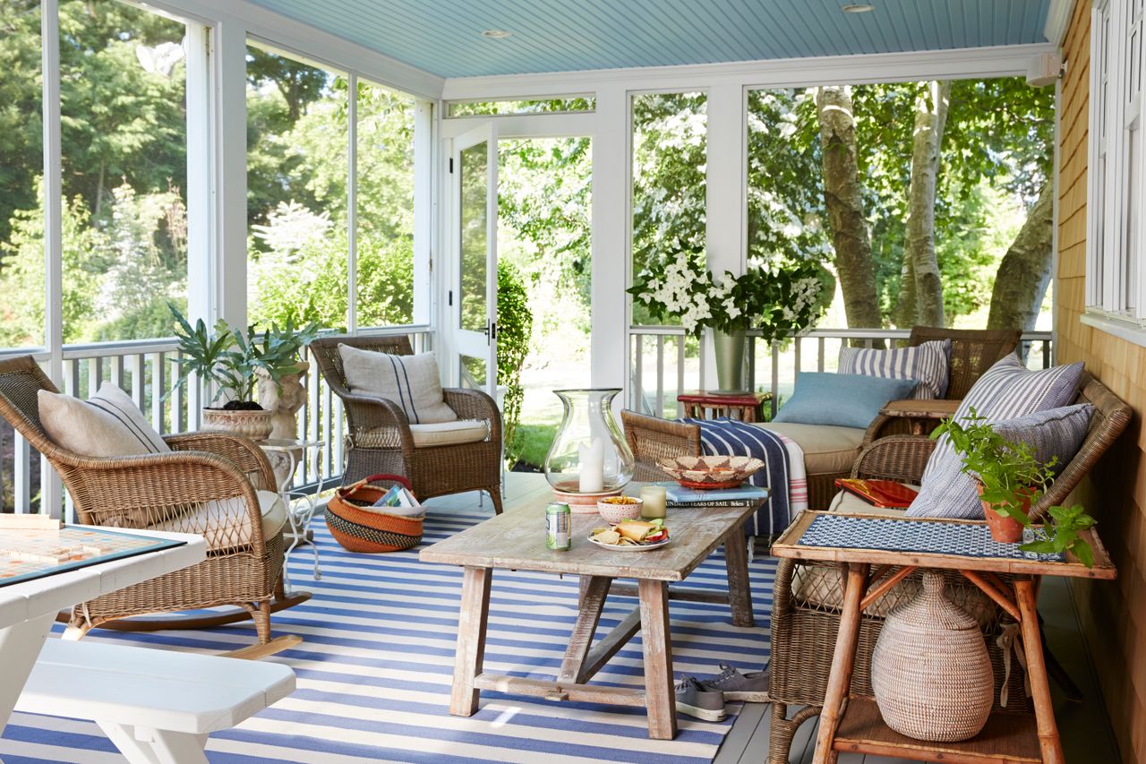 Furnished outdoor patio with seating a coffee table and decorative plants