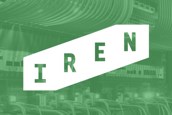 Iren logo in white set over green shaded picture of data center computer rack.