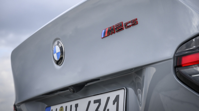 Close shot of BMW M2 CS badge on rear spoiler of vehicle with sky in background