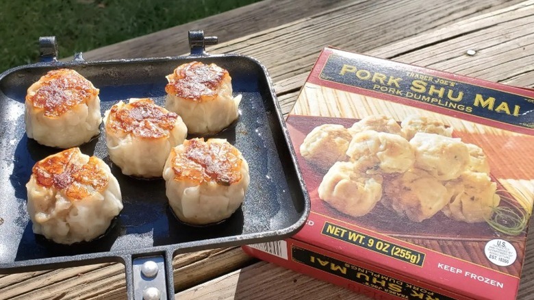 A box of Trader Joe's Pork Shu Mai prepared on a skillet