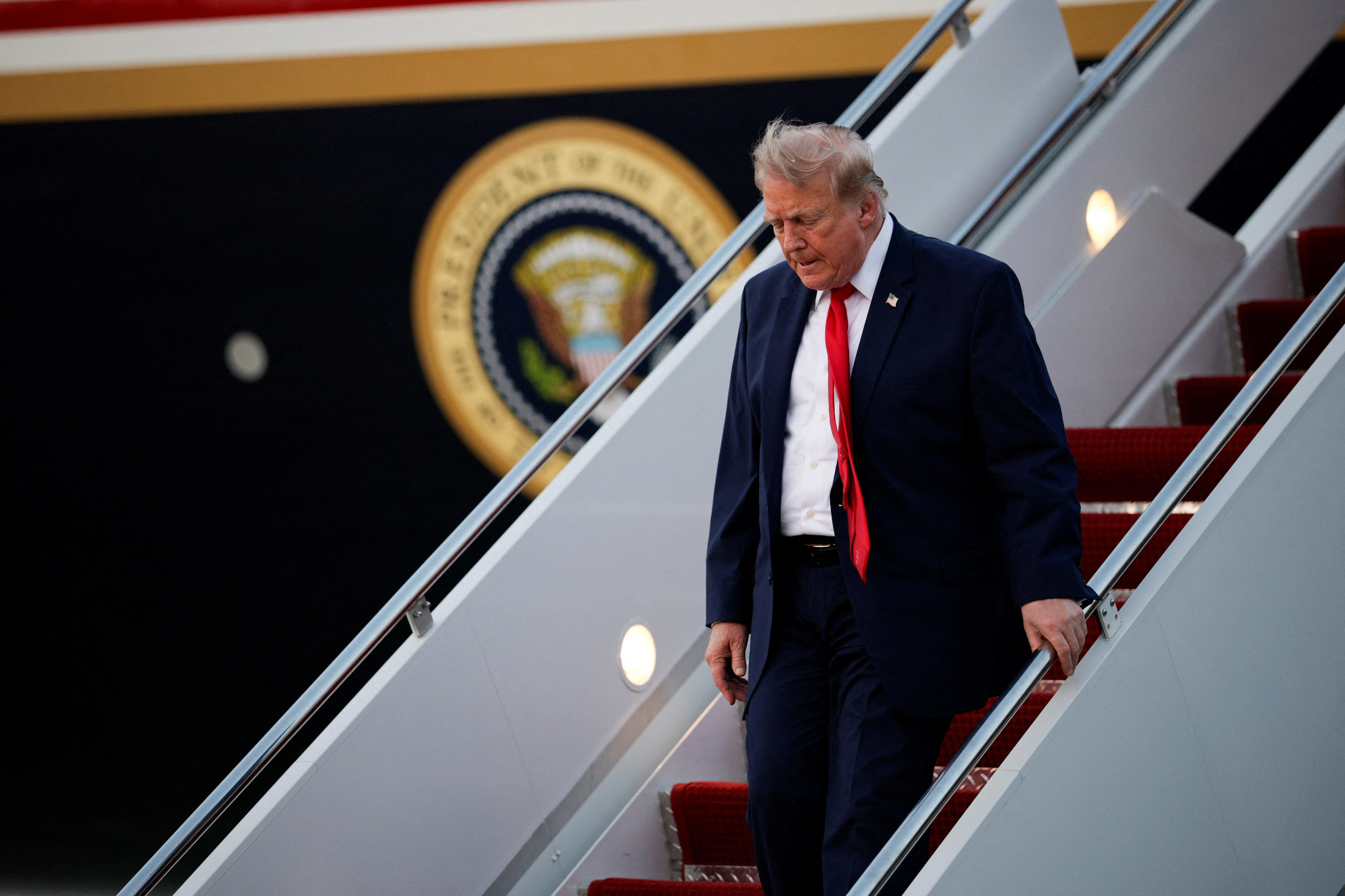 U.S. President Donald Trump deboards the plane as he arrives at Joint Base Andrews in Maryland, U.S. on July 19, 2026.