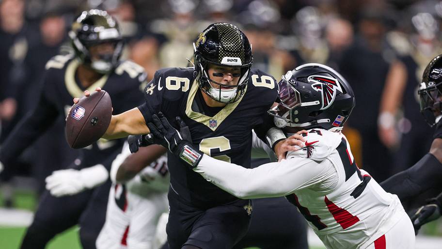 New Orleans Saints quarterback Tyler Shough is sacked by Atlanta Falcons defensive tackle Brandon Dorlus