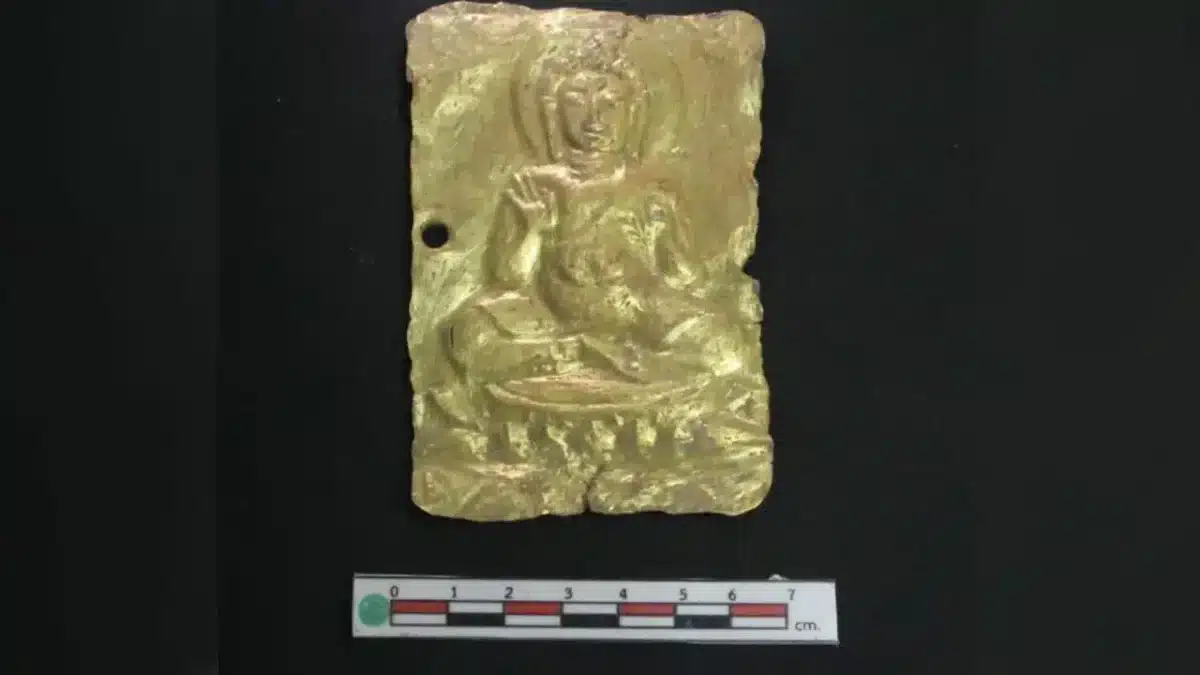A gold repoussé plaque showing a seated Buddha in a teaching pose. Credit: Thailand’s Fine Arts Department