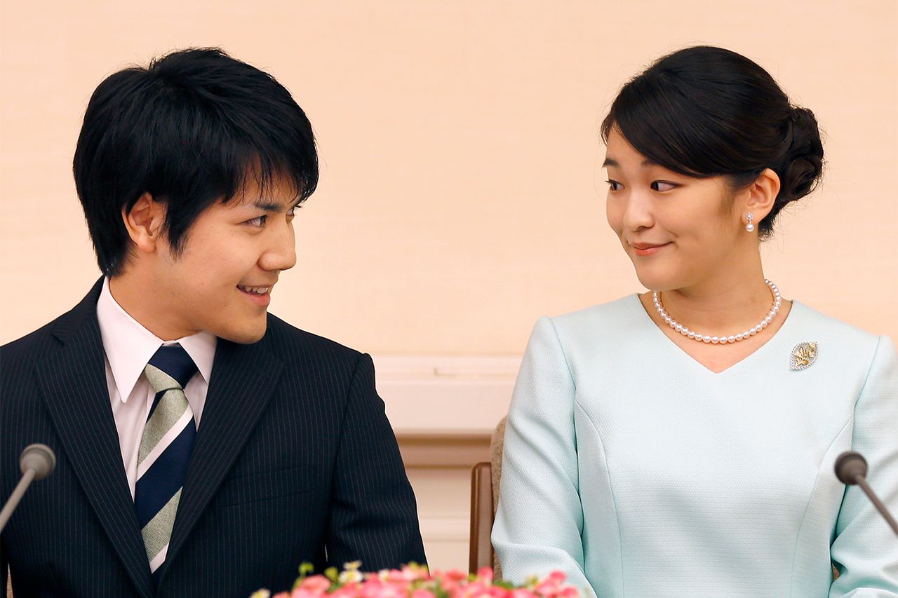 Princess Mako (R), the eldest daughter of Prince Akishino and Princess Kiko, and her fiancee Kei Komuro (L), smile during a press conference to announce their engagement at the Akasaka East Residence in Tokyo on September 3, 2017. Emperor Akihito's eldest granddaughter Princess Mako and her fiancÃ© -- a commoner -- announced their engagement on September 3, which will cost the princess her royal status in a move that highlights the male-dominated nature of Japan's monarchy.