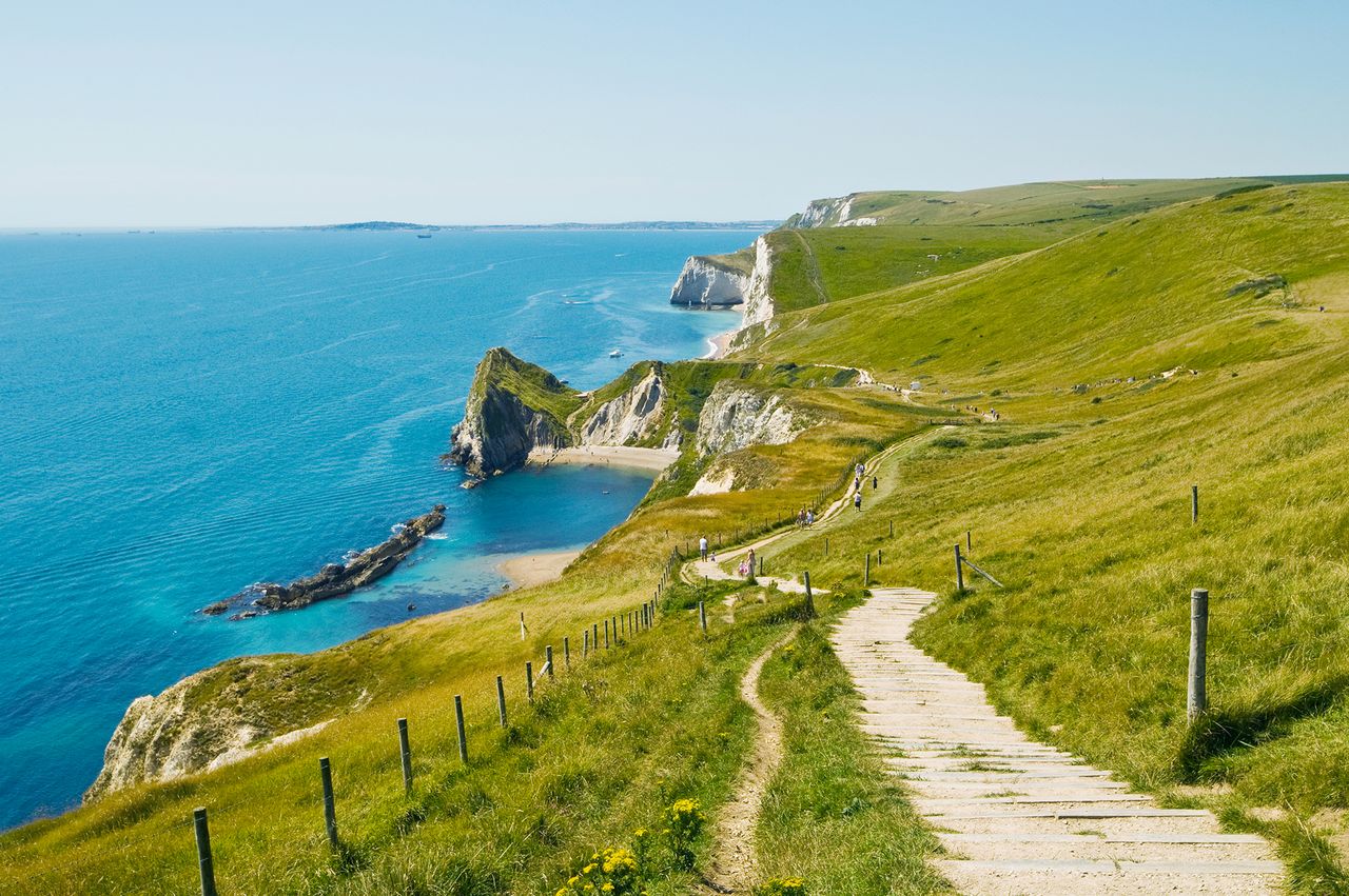 A coastal path winding along cliffs overlooking the sea