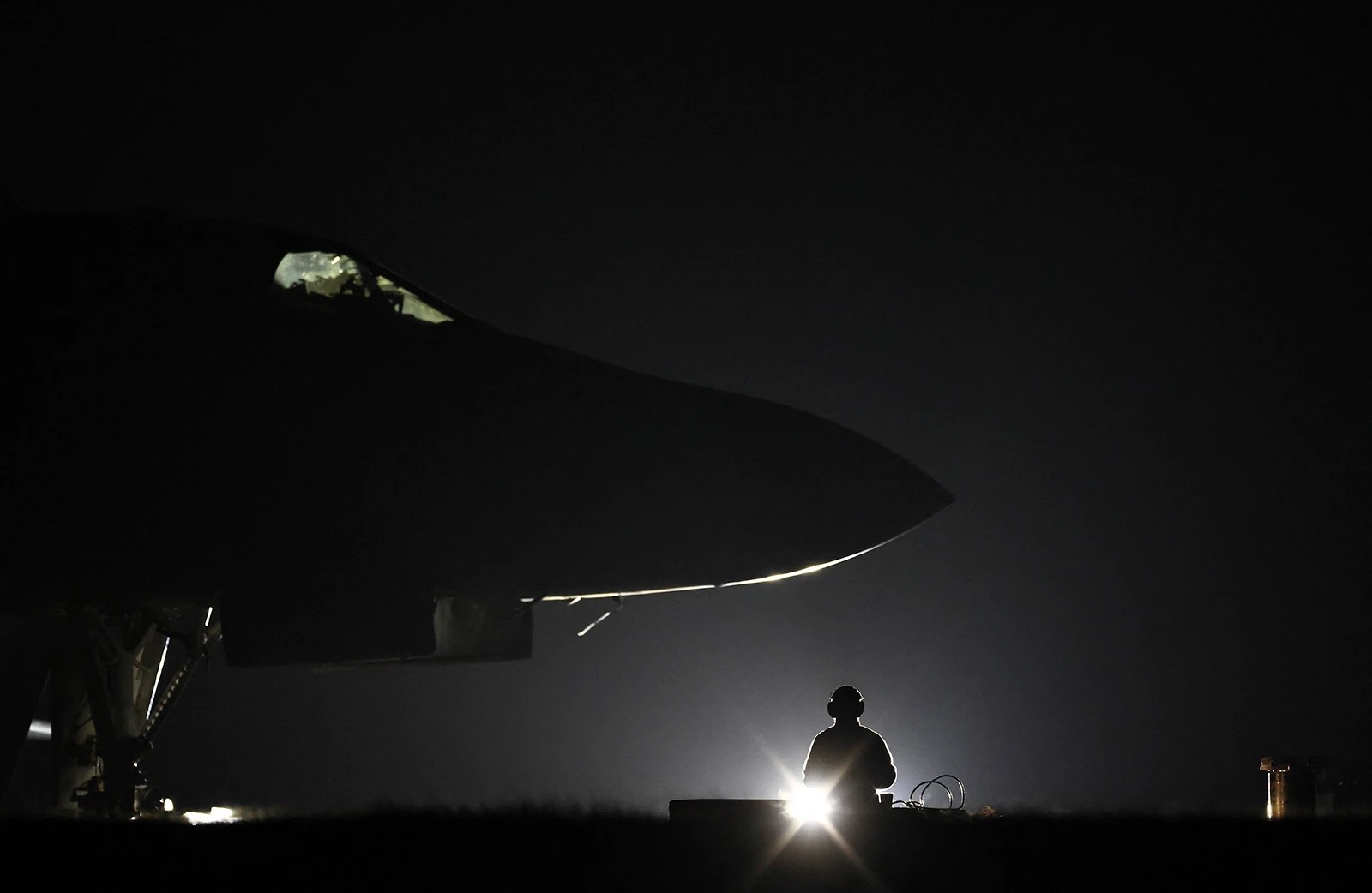 U.S. Air Force military ground personnel load Joint Direct Attack Munitions into a U.S. Air Force B-1 Lancer bomber on March 11, 2026, on the tarmac at RAF Fairford in England.