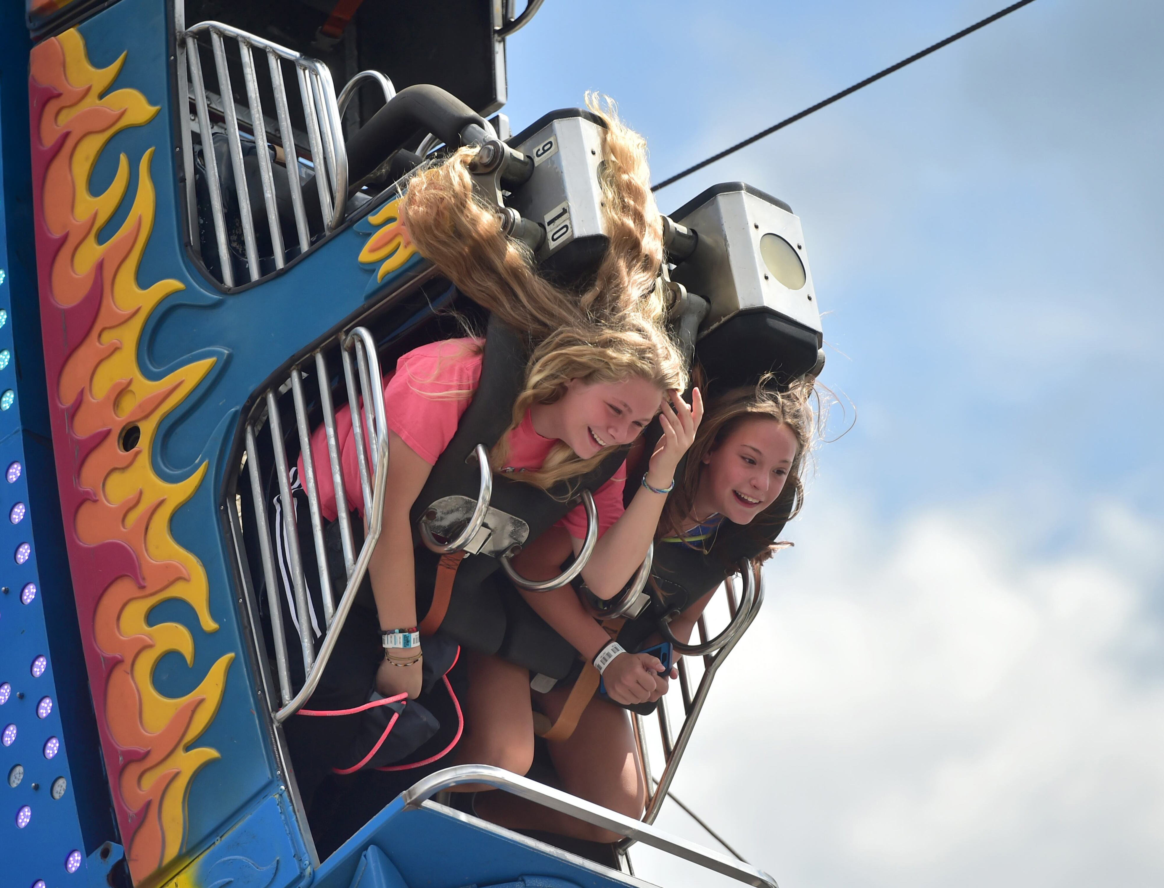 Emma Burger, left, and Bella Brown both of Oswego hold on tight during Harborfest in Oswego, NY, Friday July 27, 2018. Scott Schild | sschild@syracuse.com