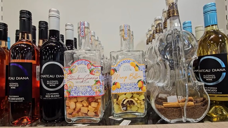 Several bottles of alcohol-free wine and cocktail kits in bottles on a shelf at HomeGoods.