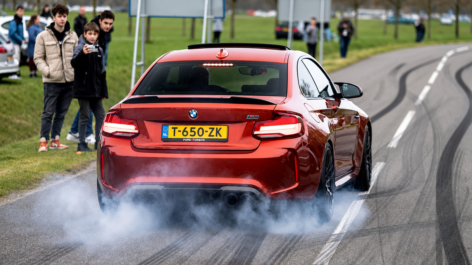 Loud BMW driver steals the show leaving a car meet with a massive burnout