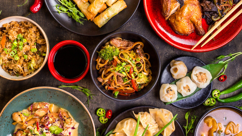 a variety of Chinese dishes on a black table