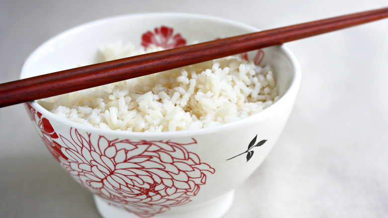 bowl of rice with wooden chopsticks