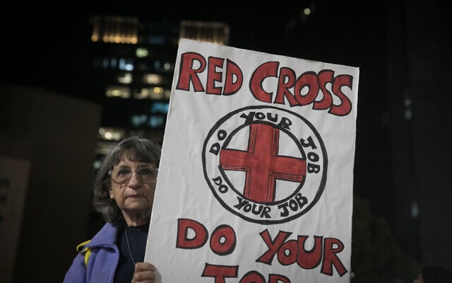 A protester against the Red Cross at Hostages Square in Tel Aviv, December 14, 2023. (Miriam Alster/Flash90)